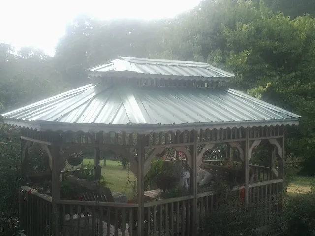 Two tier green metal roof on a garden gazebo in Edmonton