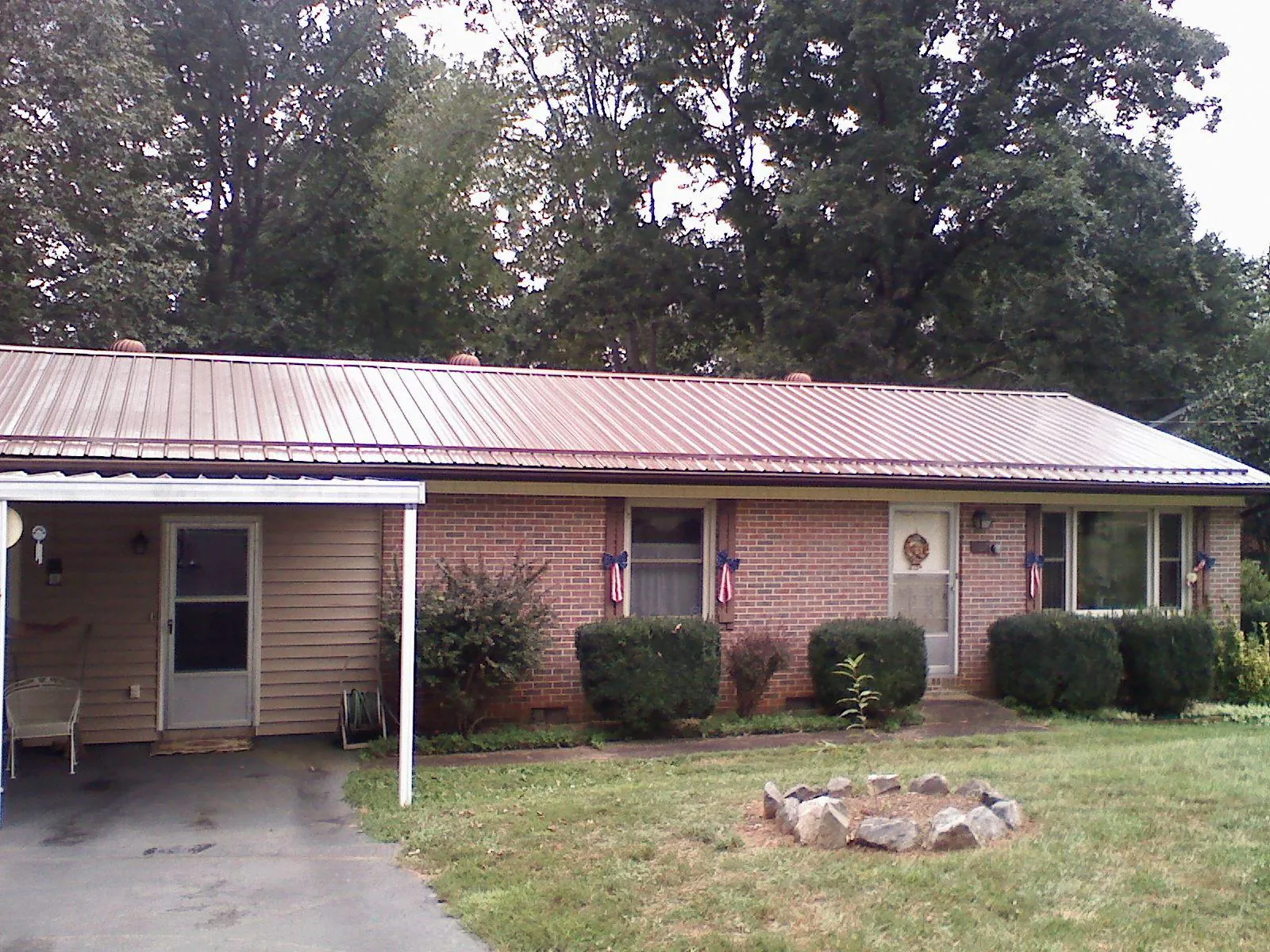 Bronze metal roof and carport on a brick ranch home — Roof Repair work by our crew in Edmonton